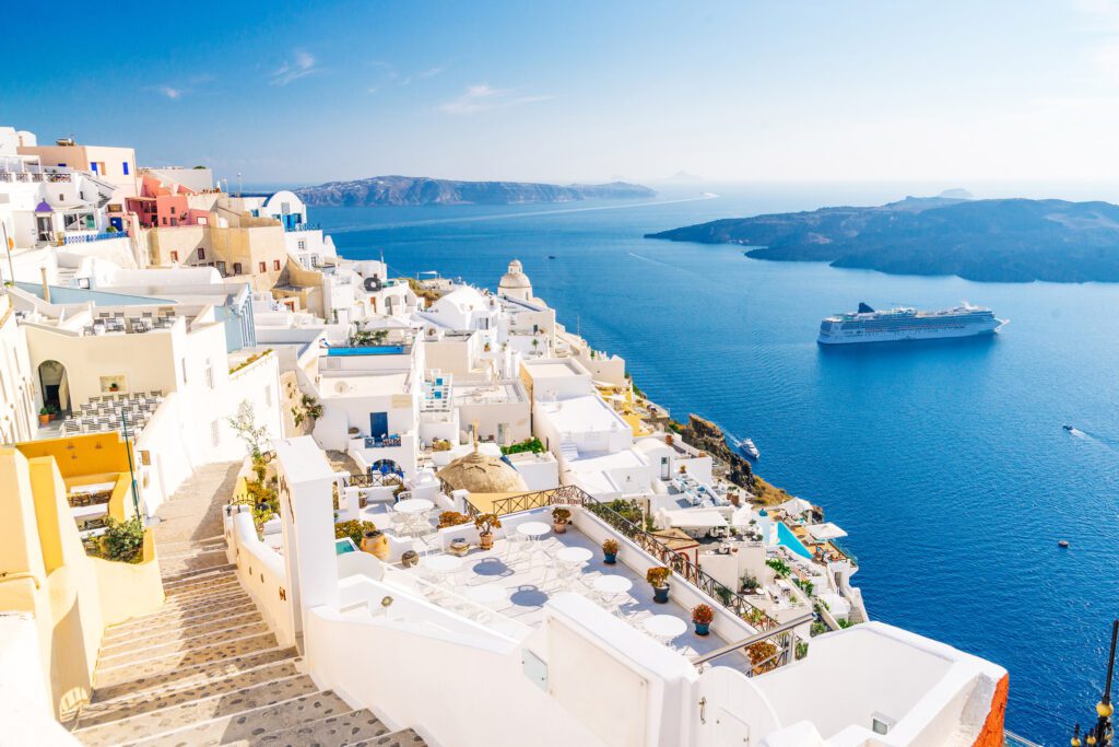 Fira town capital of santorini with nice cladera view and cruise ship visible near volcano