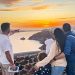 The best excursion in Santorini by Mocanu Travel with a family close by Oia village at sunset time