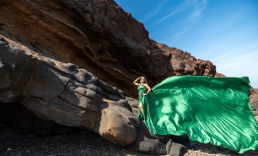Green dress santorini at the black beach