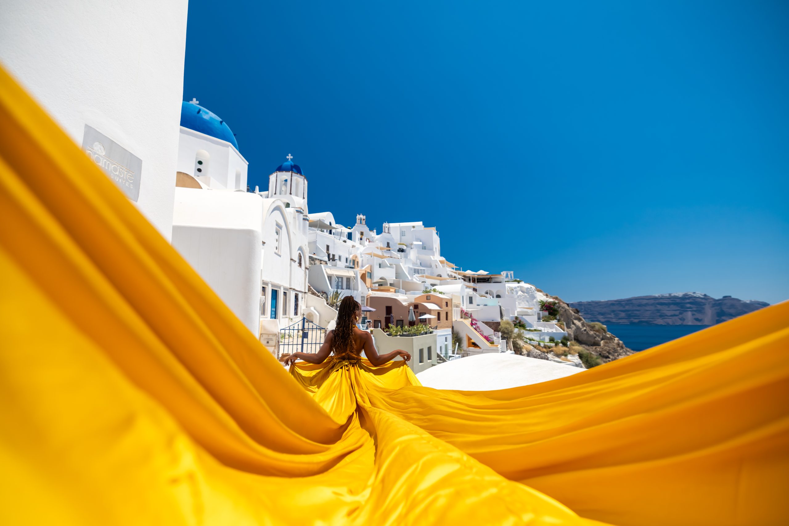 gold flying dress santorini at caldera