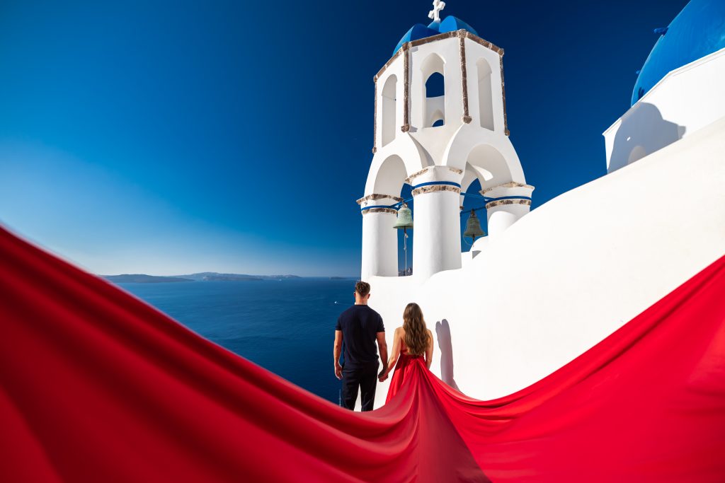 red flying dress photography for couples in Santorini