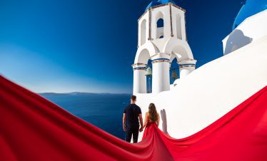 red flying dress photography for couples in Santorini