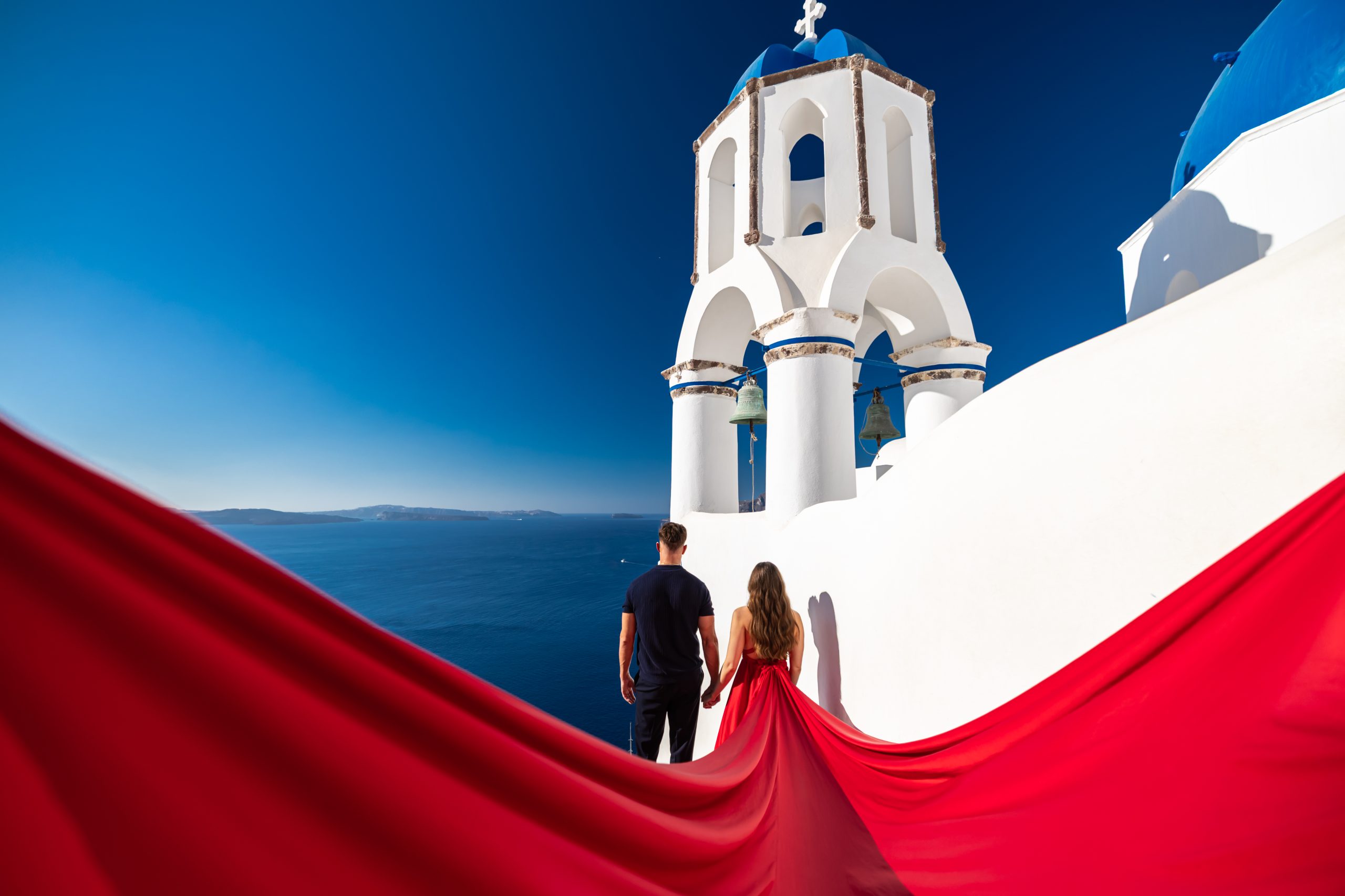 red flying dress photography for couples in Santorini