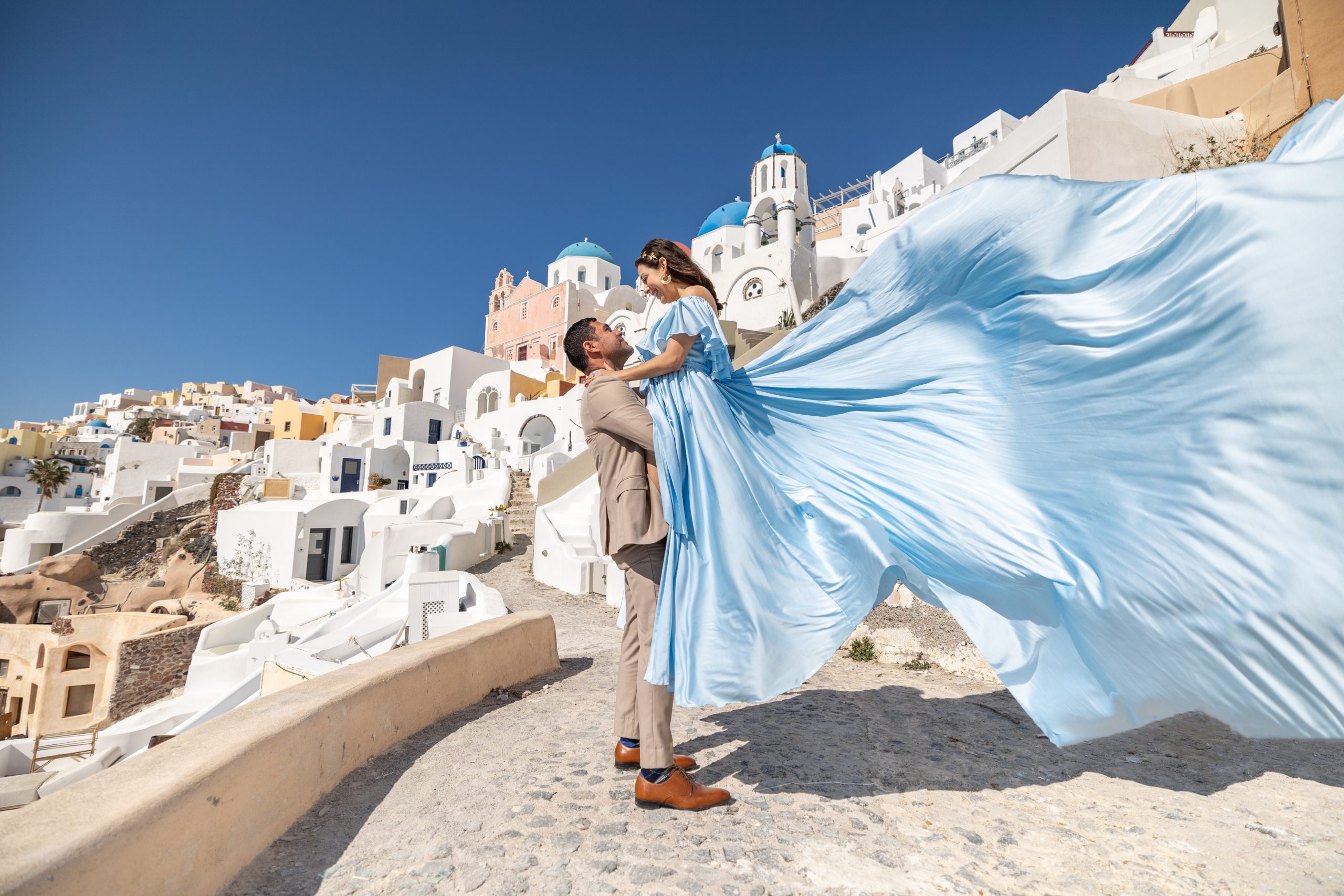 couple flying dress photoshoot in Santorini